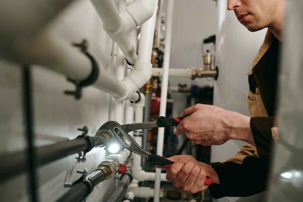 Plumbers maintaining commercial plumbing pipes in Seminole