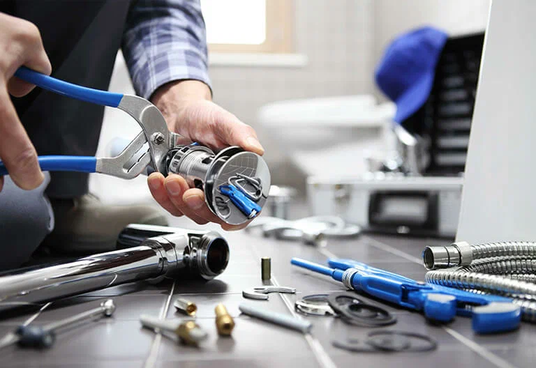 Technician repairing a plumbing fixture with professional tools in Seminole