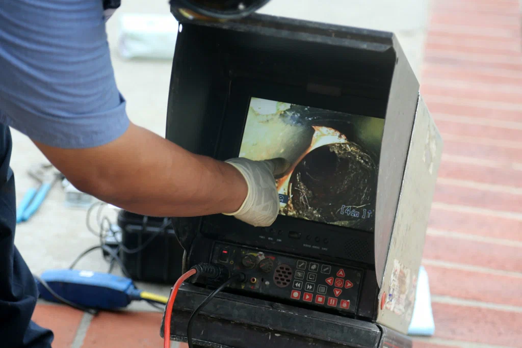 Technician viewing a drain inspection camera in Seminole