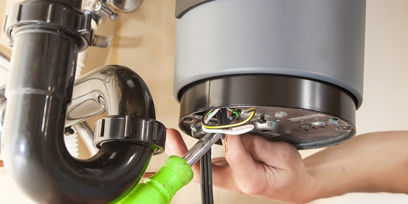 Technician repairing the heating element of a water heater in Seminole