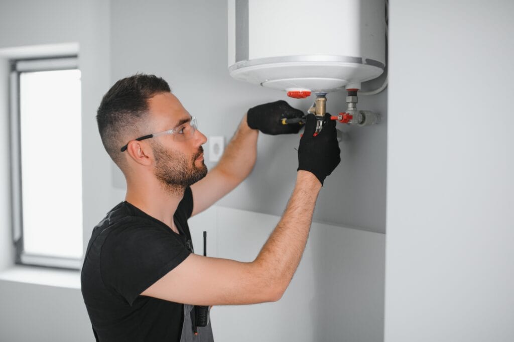 Technician performing water heater maintenance in Seminole