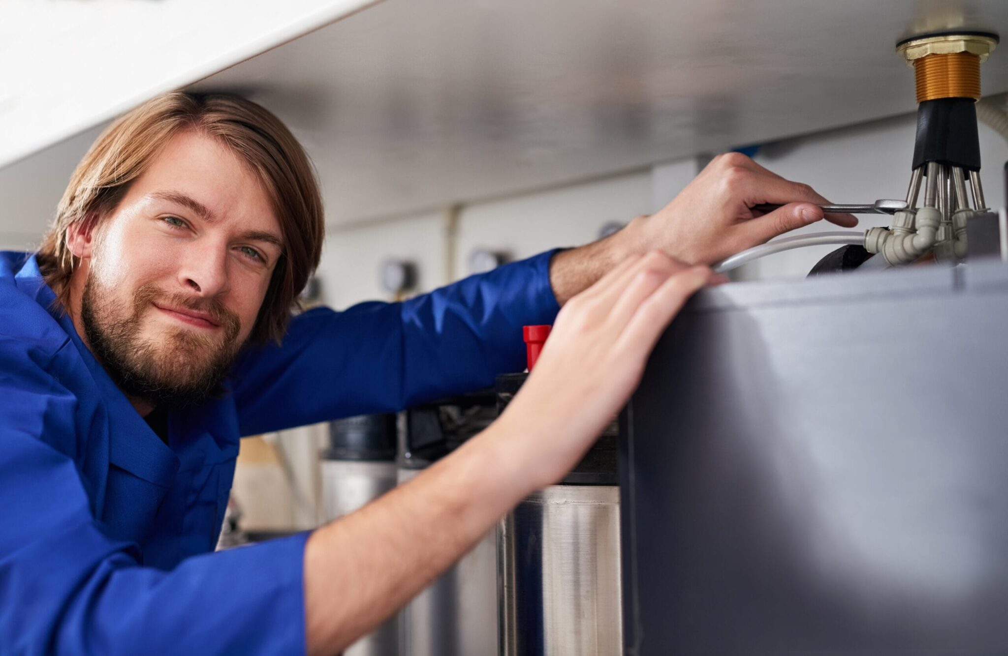 Technician servicing a residential water heater tank in Seminole