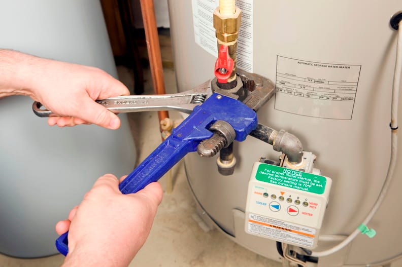 Plumber repairing a water heater valve in Seminole
